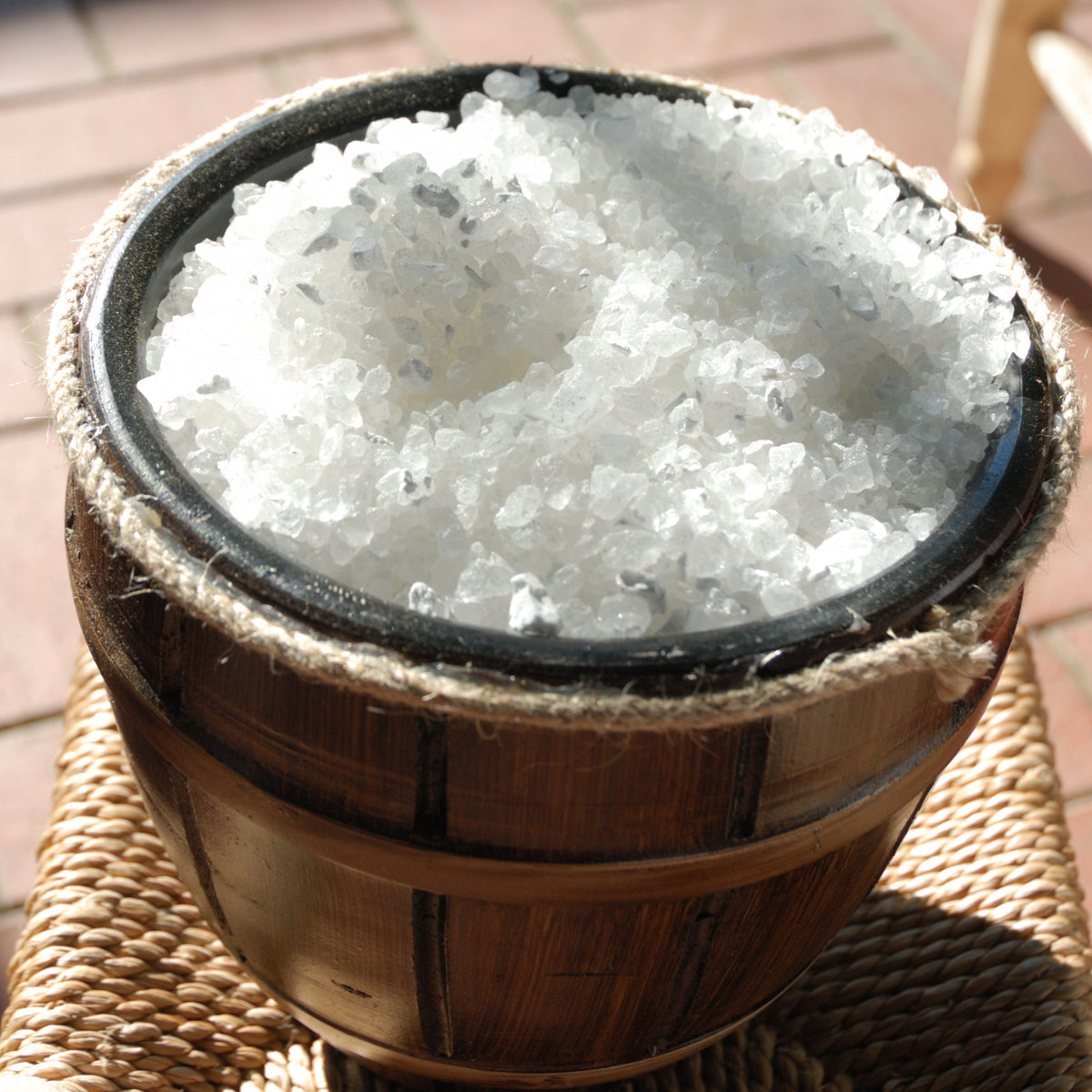 Close-up of white Citric Acid crystals in a dark bowl, from The Herb Shed Wollongong Australia.