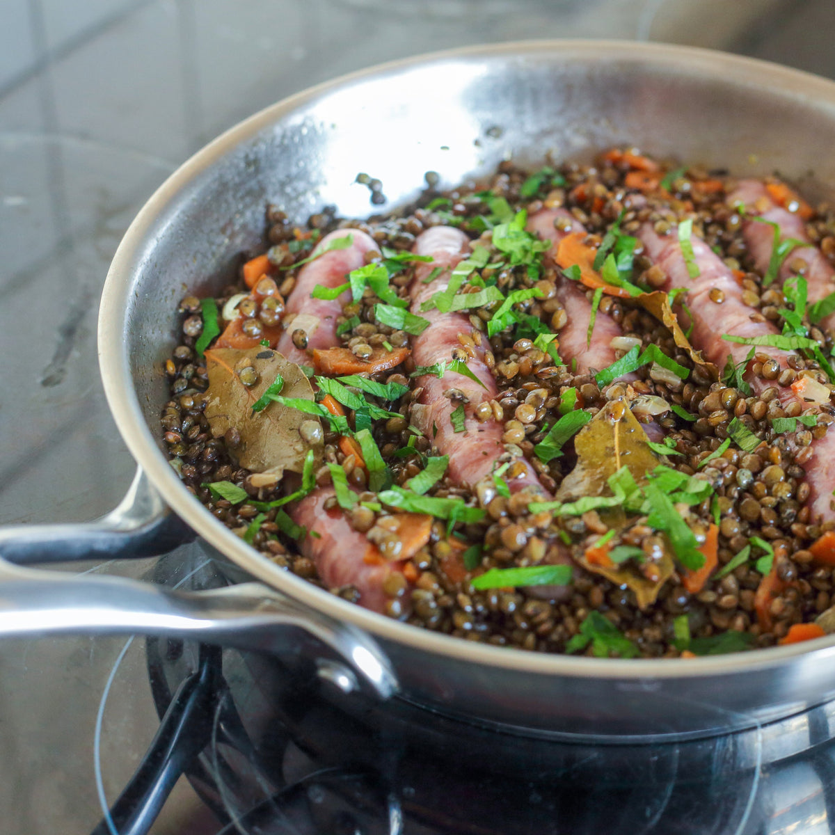 Cooked French Style Lentils garnished with fresh herbs in a pan, showing French Style Lentils from The Herb Shed in Wollongong, Australia, prepared as a savoury dish.