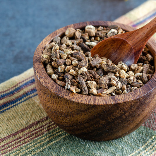 A close-up of Organic Dandelion Dried Root Tea from The Herb Shed Wollongong, Australia, showing the chopped dried root pieces with their naturally varied brown and beige colouring and woody texture.