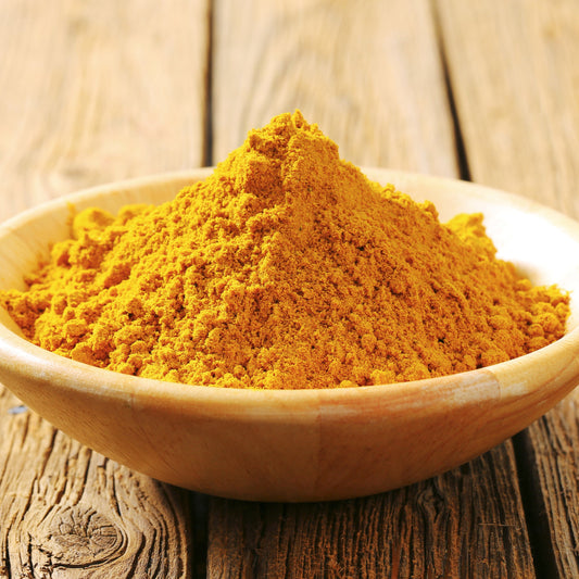 A close-up of Organic Hot Curry Powder from The Herb Shed Wollongong, Australia, showing the finely ground spice blend with its rich golden-orange colouring.