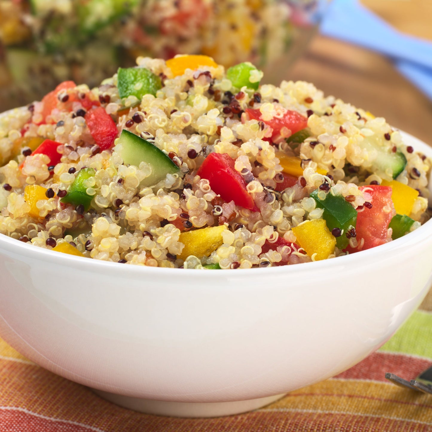 Prepared organic white quinoa salad with fresh vegetables