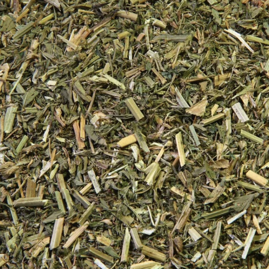 Loose-cut dried alfalfa herb with mixed leaf and stem pieces, photographed up close for texture — The Herb Shed, Wollongong.
