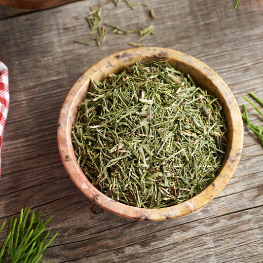 Dried horsetail in a wooden bowl on a rustic wooden table – earthy green herbal stem from The Herb Shed Wollongong
