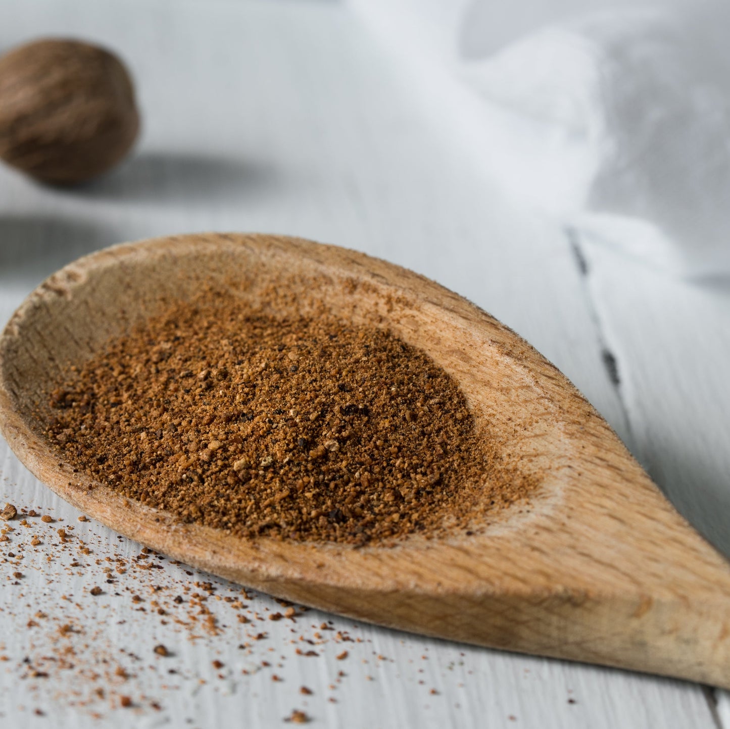 Organic ground nutmeg with wooden scoop from The Herb Shed Wollongong