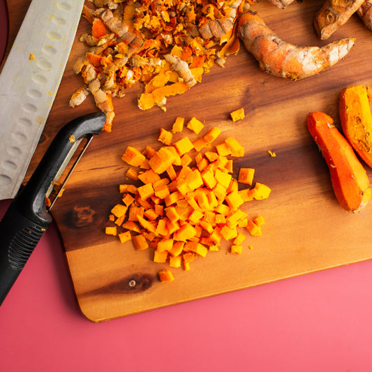 Organic turmeric root pieces on wooden board from The Herb Shed Wollongong