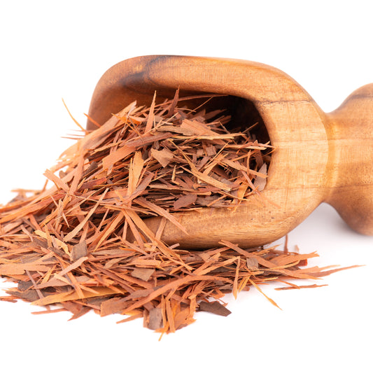 Wooden scoop filled with Pau d'Arco tea spilled onto a white background – earthy herbal bark from The Herb Shed Wollongong