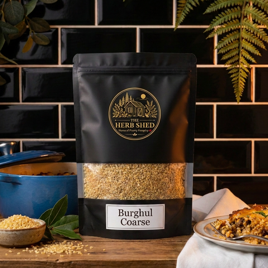 A black stand-up pouch of Herb Shed Burghul Coarse spice mix stands on a wooden shelf against a black tiled wall. The pouch has a clear window showing the coarse beige-brown spice inside.