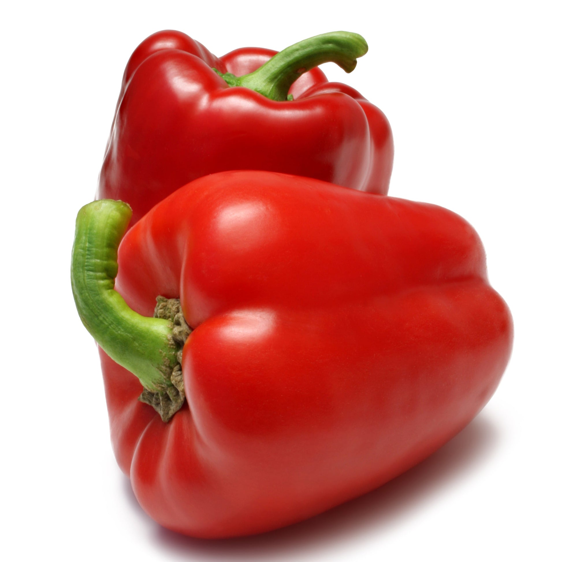 Two fresh red bell peppers with green stems, photographed on a clean white background.
