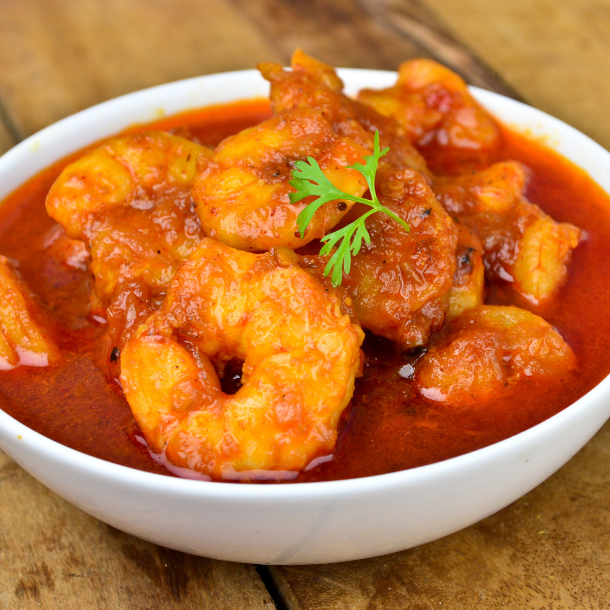 A rich tomato-based dish with pieces of meat and herbs, showing Bay Leaves used to add flavour during savoury cooking.