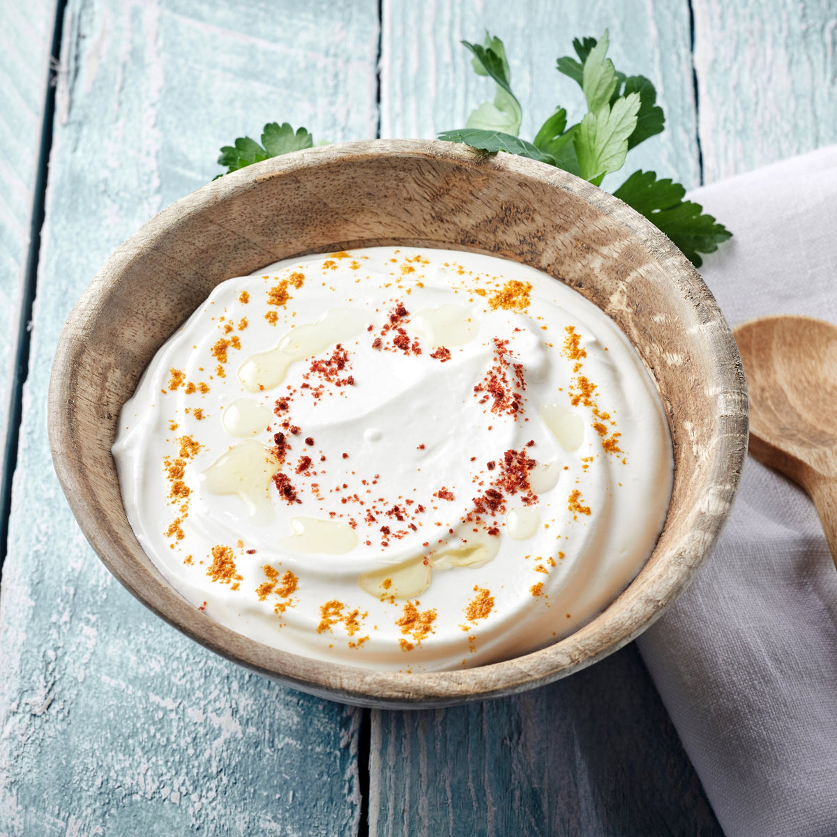 A creamy dip topped with a sprinkle of Cayenne Pepper and fresh herbs, showing the ground spice used to add heat and colour to a savoury dip.