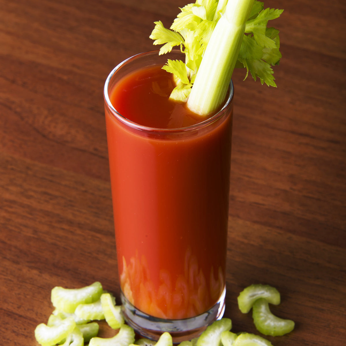 A glass of spicy tomato drink garnished with celery and lime, showing Cayenne Pepper used to add heat to a savoury tomato-based drink.