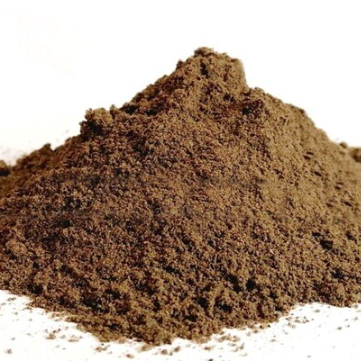 A mound of Chaste Tree Berry Powder against a white background, showing its finely ground texture and natural earthy brown colouring.