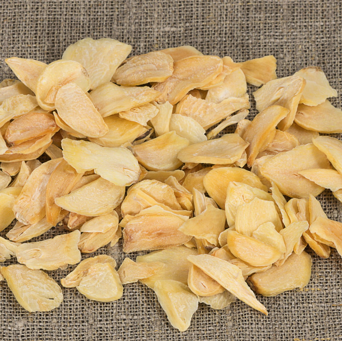 A close-up of Dried Garlic Flakes Sliced from The Herb Shed Wollongong, Australia, showing the thin irregular garlic pieces with their naturally pale golden colouring.