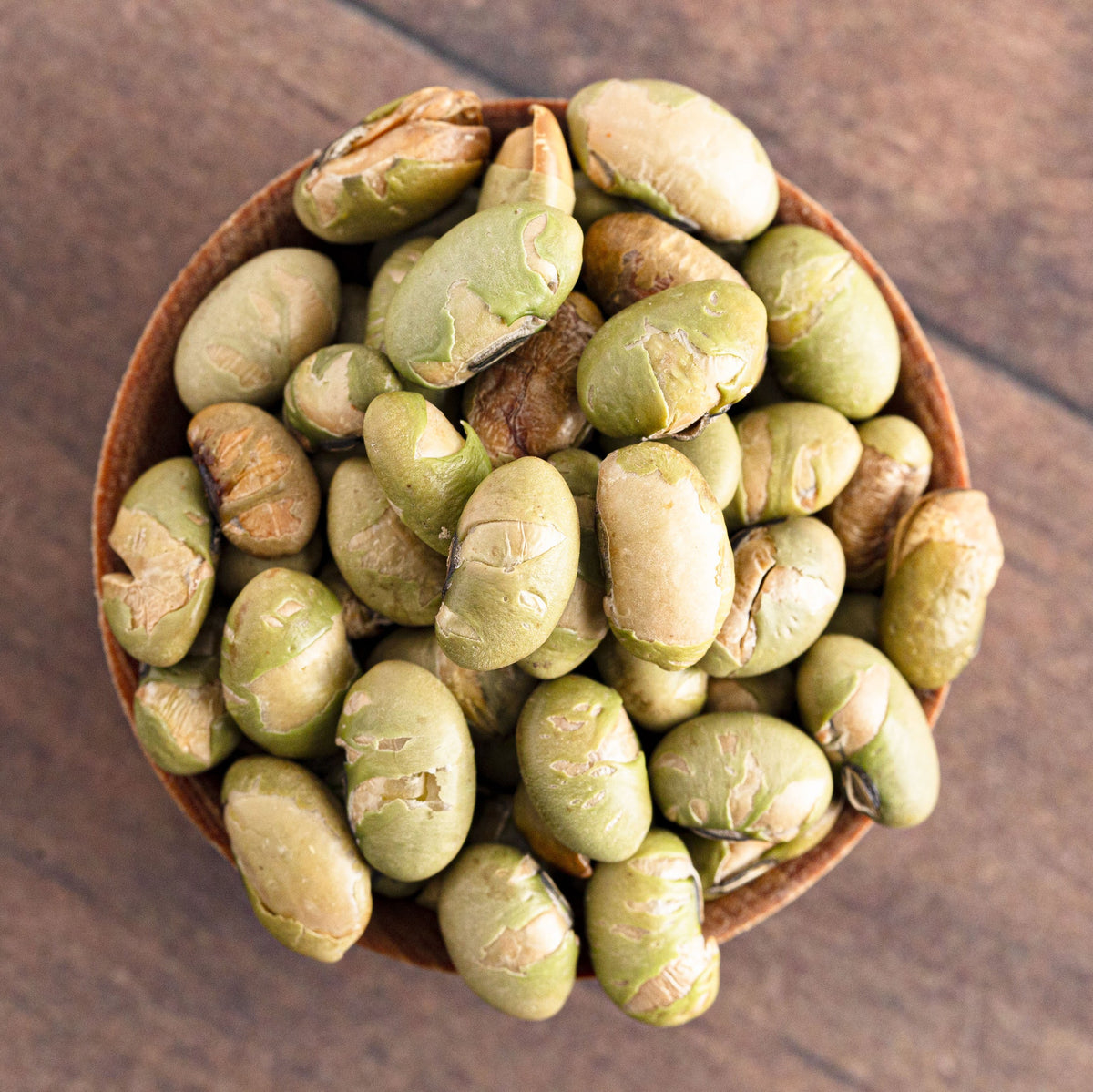 Dry Roasted Salted Edamame piled in a wooden spoon, showing the pale green beans and lightly roasted surface, from The Herb Shed Wollongong Australia.