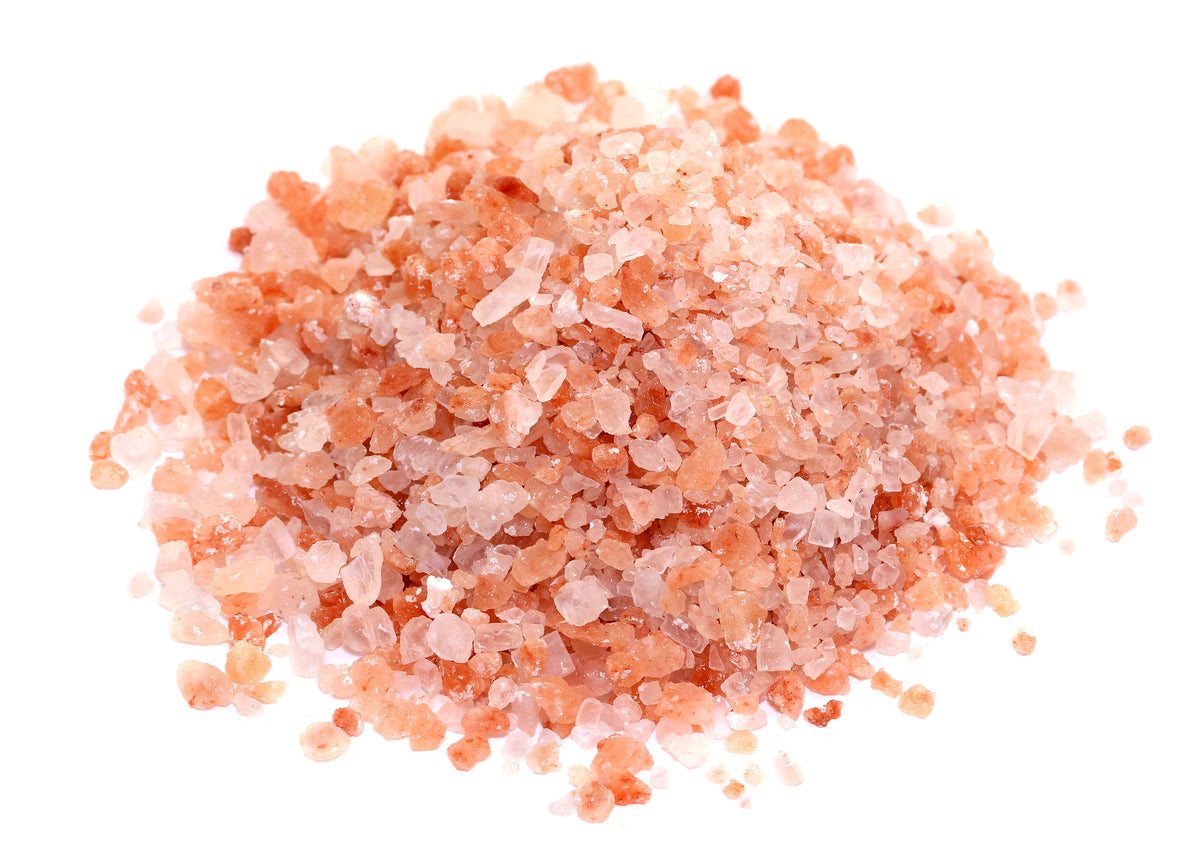 A close-up pile of coarse Himalayan Pink Salt crystals showing natural shades of pale pink, coral and white, from The Herb Shed Wollongong Australia.