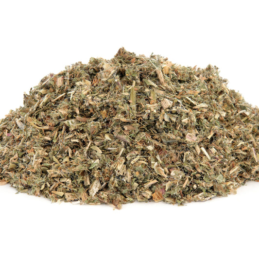 A pile of Organic Blessed Thistle dried herb sits against a white background, showing the cut leafy texture and natural green and brown colouring of the dried herb.
