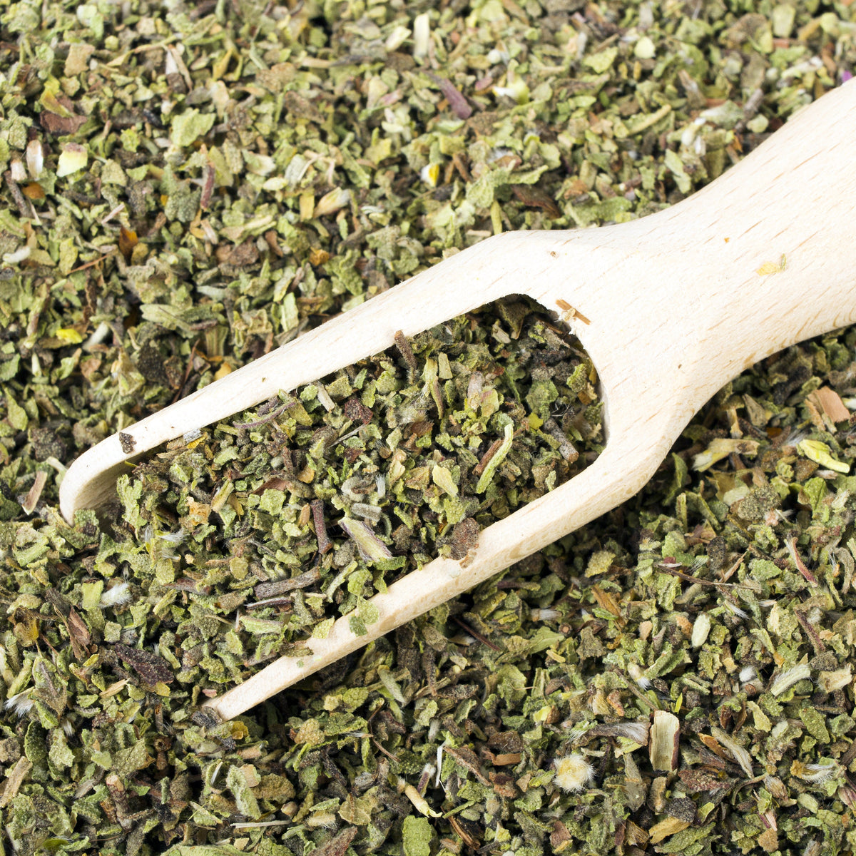 Close-up of dried Organic Cistus Rock Rose leaves in a wooden scoop, from The Herb Shed Wollongong Australia.