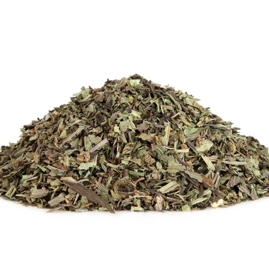 A pile of loose dried plantain shows the cut green and brown leaves and coarse texture of the dried herb.