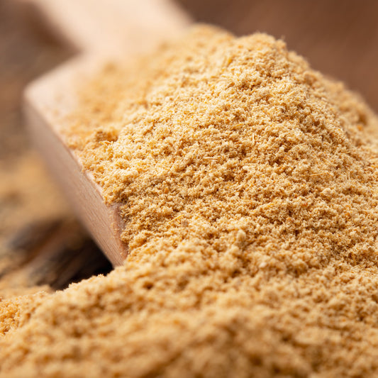 A close-up of Organic Ginger Powder from The Herb Shed Wollongong, Australia, showing its finely ground texture and naturally warm pale golden colouring.