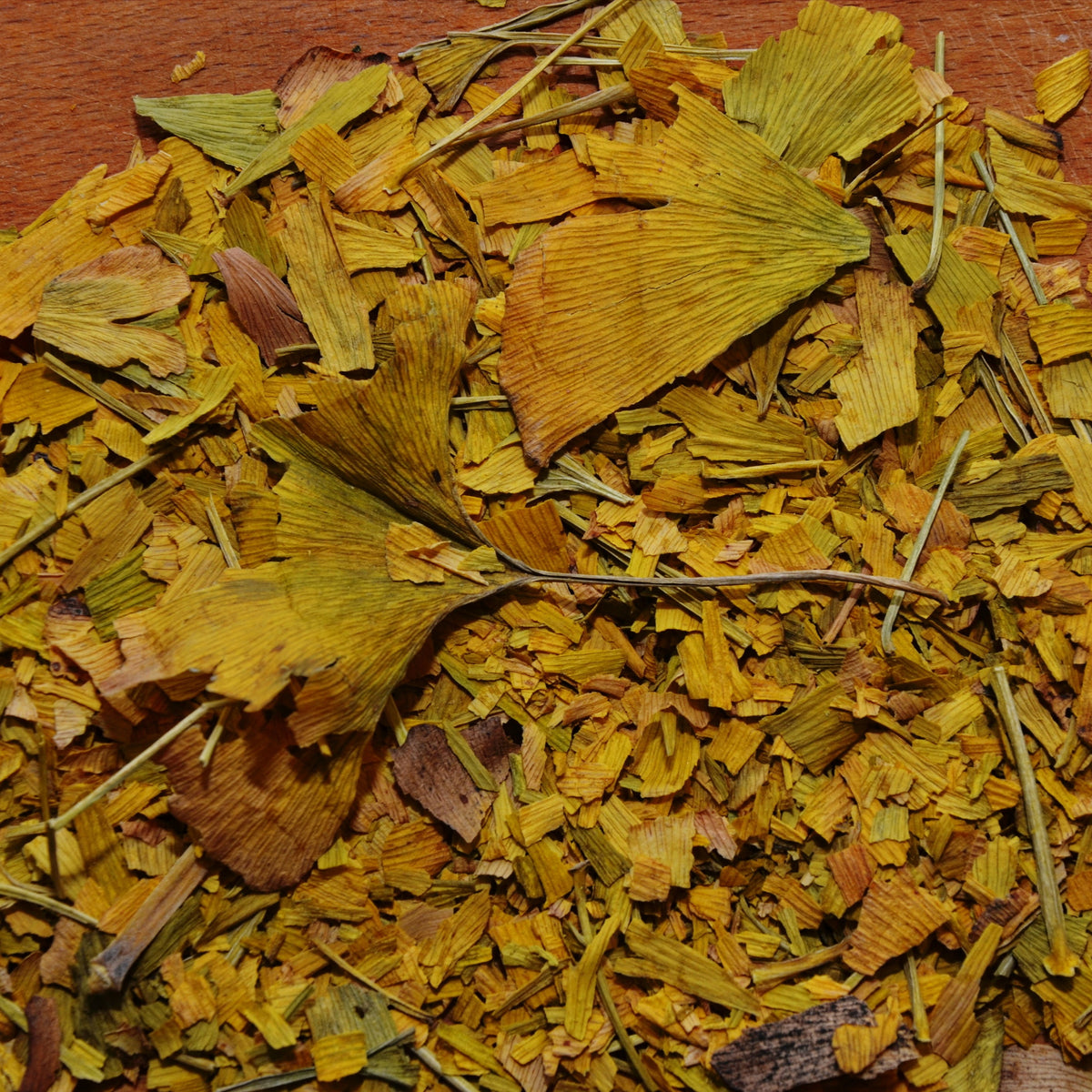 A close-up of Organic Ginkgo from The Herb Shed Wollongong, Australia, showing the cut dried leaves with their naturally varied yellow-green and brown colouring and leafy texture.