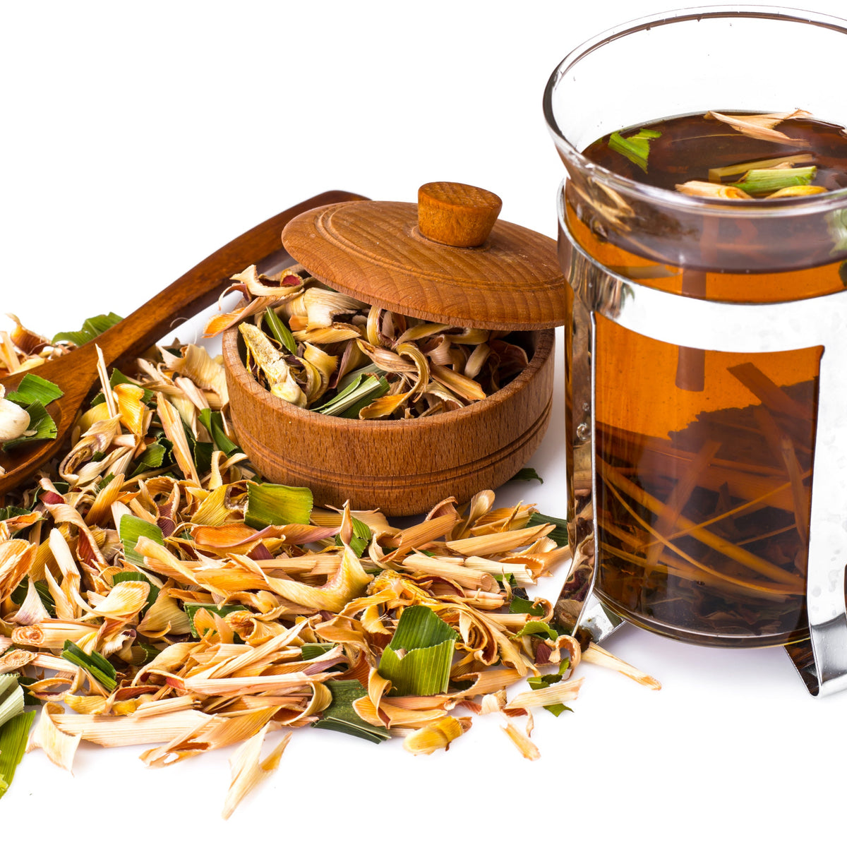 A glass cup of golden herbal tea beside loose dried lemongrass, showing Organic Lemongrass Dried from The Herb Shed in Wollongong, Australia, prepared as a herbal infusion.