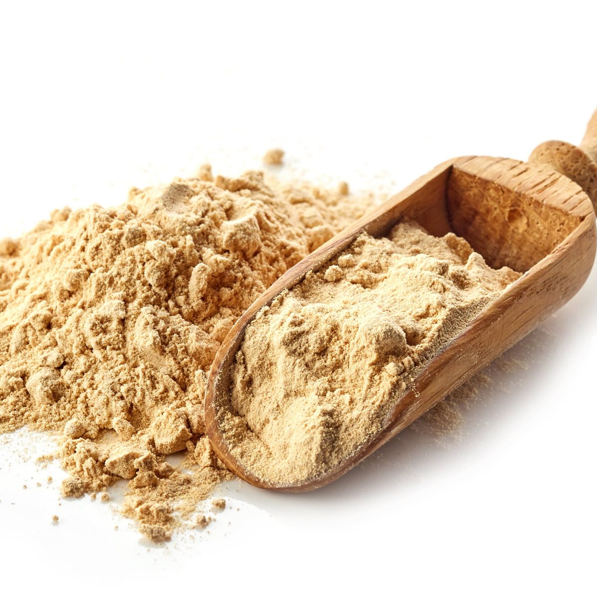 Organic maca powder is piled beside a wooden scoop filled with powder, showing its fine texture and natural pale beige colour.