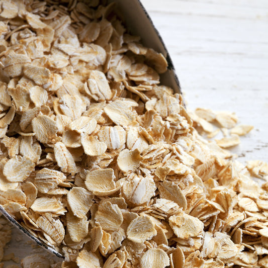 A close-up of Organic Rolled Oats from The Herb Shed Wollongong, showing the flattened whole oat flakes with their natural creamy beige colour and lightly textured surface.