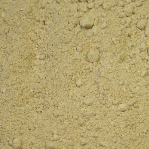 A close-up of organic tribulus powder showing its fine, pale beige colour and softly ground texture.