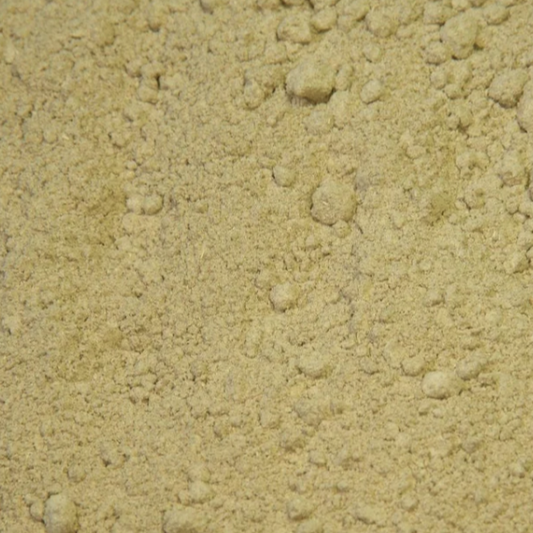 A close-up of organic tribulus powder showing its fine, pale beige colour and softly ground texture.