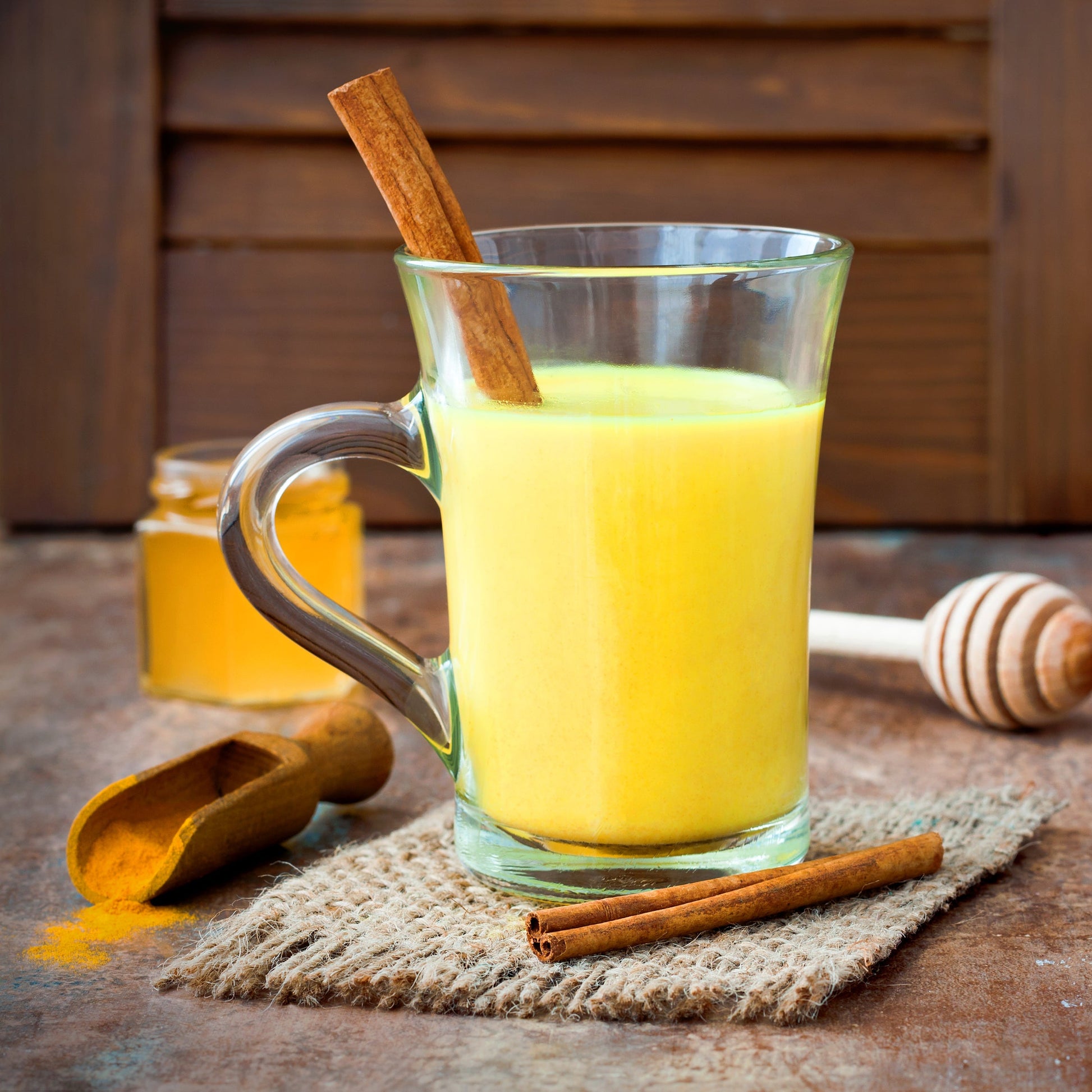 Golden turmeric drink being poured into a glass
