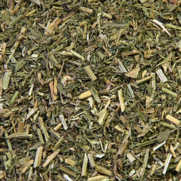 Loose-cut dried alfalfa herb with mixed leaf and stem pieces, photographed up close for texture — The Herb Shed, Wollongong.