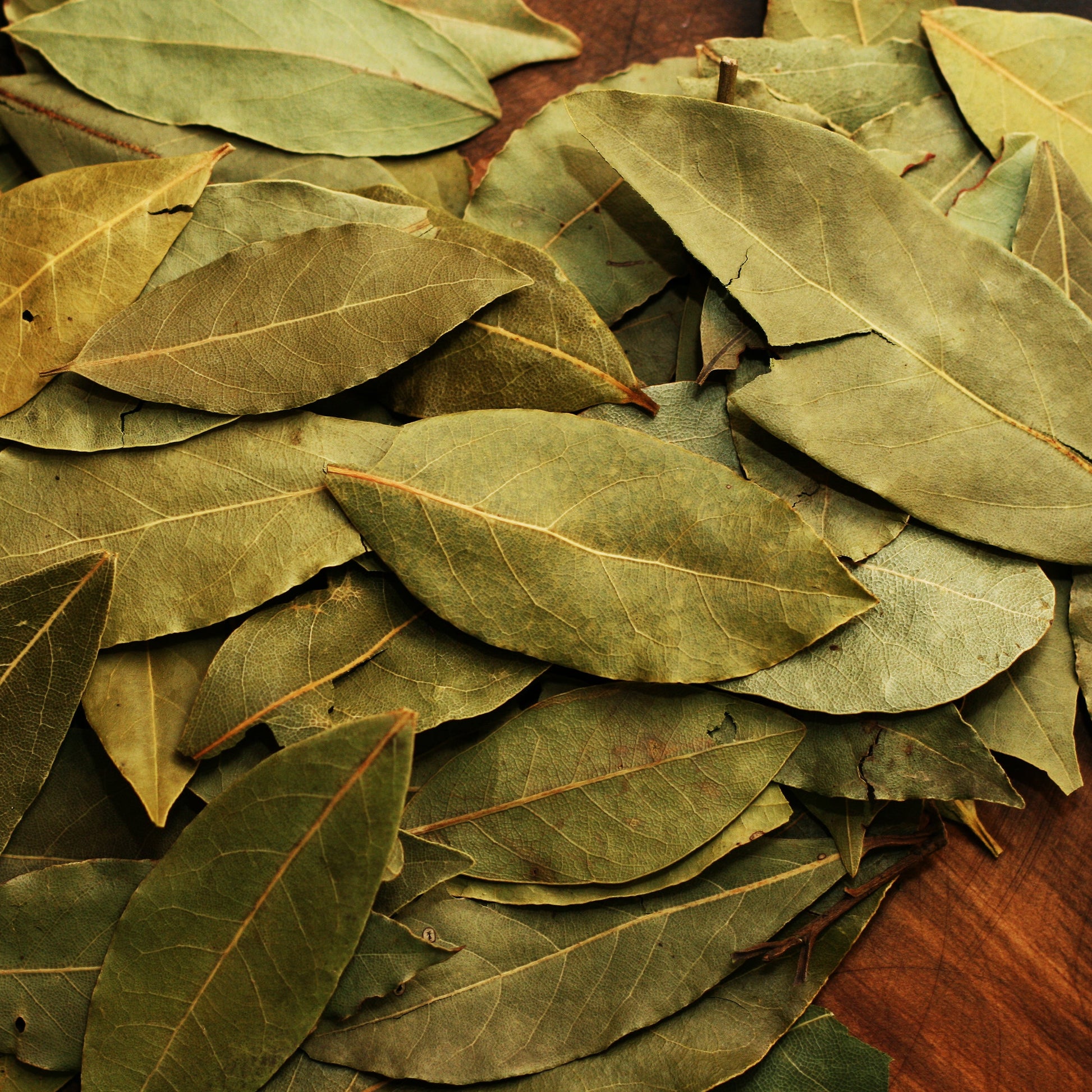 Pile of bay leaves on a table – fragrant, earthy herb from The Herb Shed Wollongong