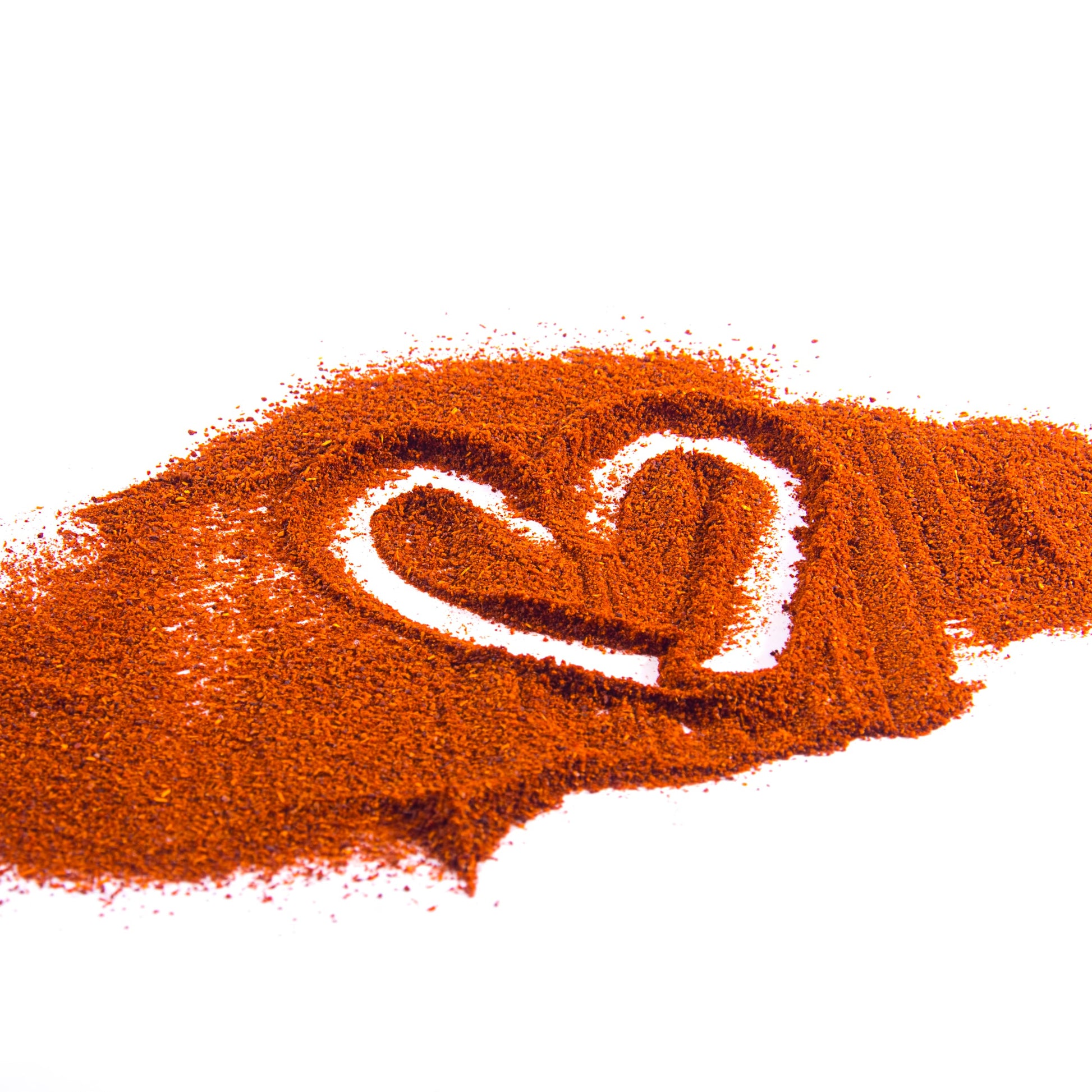 Hot paprika powder shaped into a hand-drawn love heart – smoky red spice from The Herb Shed Wollongong